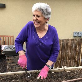 Picture of Susan in the garden prepping the beds for new herbs and vegetables