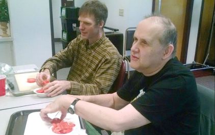 Picture of clients learning how to safely cut tomatoes